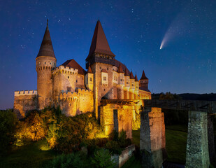 Fototapeta na wymiar Comet in night sky over Corvin Castle, Hunedoara, Transylvania, Romania