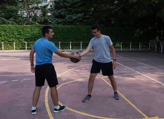 two teenage players holding the basketball before a game