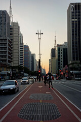 Naklejka premium famous Paulista avenue in Sao Paulo city, at sunset. buildings and traffic in the financial center