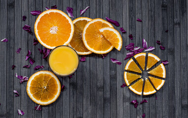 
Orange juice. Sliced ​​oranges on dark background.