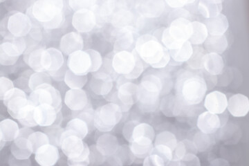 Silver glitter festive background with bokeh lights. Celebration concept for Holidays and...