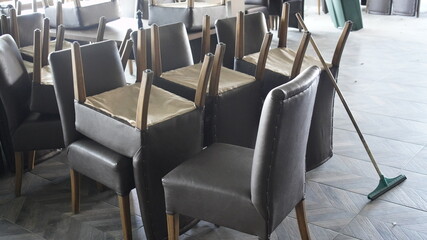 Wooden Chairs areUpside Down On Wooden Table in Restaurant for Cleaning Floor
