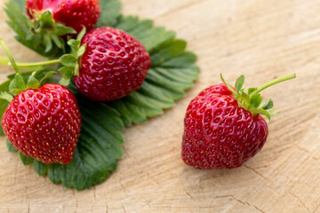 Fresh strawberries on a wooden table. Farmed organic food. Healthy eating.