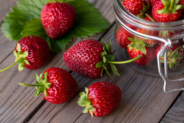 Fresh strawberries on a wooden table. Farmed organic food. Healthy eating.