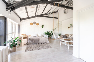 Luxury bedroom design in a rustic cottage in a minimalist style. white walls, panoramic windows, wooden elements of decoration on the ceiling, rope swings in the middle of a spacious room