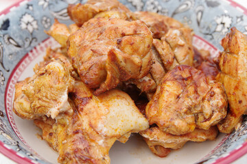 Chicken shashlik. Shashlik or Shish kebab popular in Eastern Europe. Marinated shashlik preparing on a barbecue grill over charcoal. Chicken hip barbecue. Fried meat in plate.