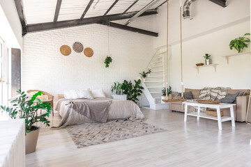 Luxury bedroom design in a rustic cottage in a minimalist style. white walls, panoramic windows, wooden elements of decoration on the ceiling, rope swings in the middle of a spacious room