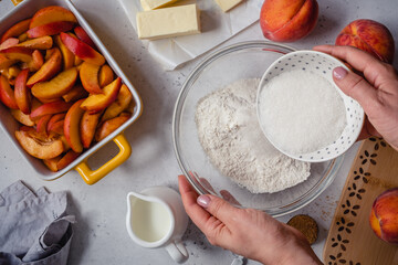 White table with ingredients for peach cobbler pie