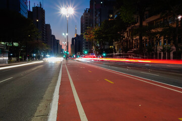 Paulista avenue in Sao Paulo city, at night. Light trails and buildings
