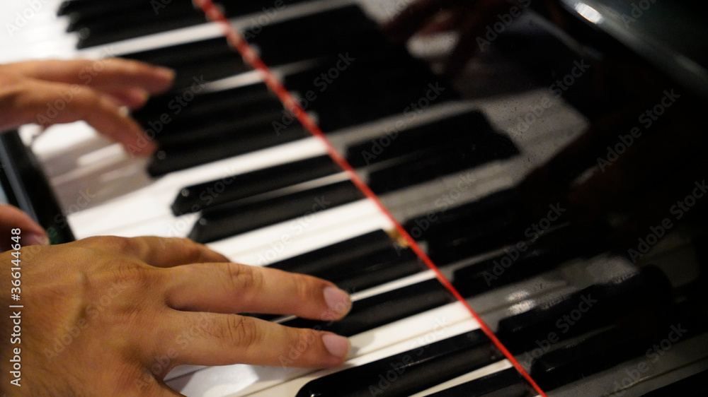 Wall mural man hands of a pianist play the piano.