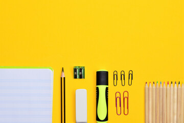 Back to school. School supplies and newspapers at school, on yellow background, space for text