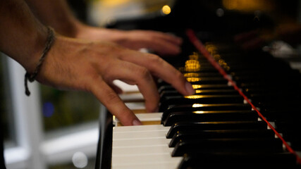 Man hands of a pianist play the piano.