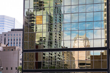 Fototapeta na wymiar reflection of buildings in the glass of another building