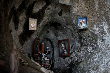 small church with pictures of saints in a bedrock cave high in the mountains