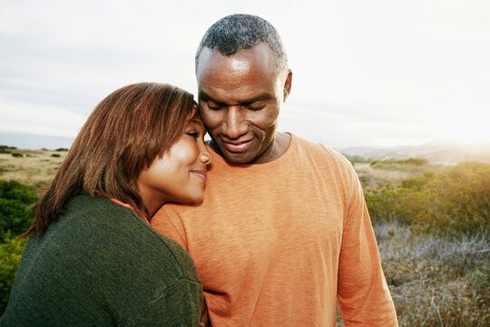 Black Couple Hugging On Rural Hillside