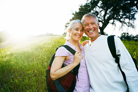 Caucasian couple smiling in tall grass