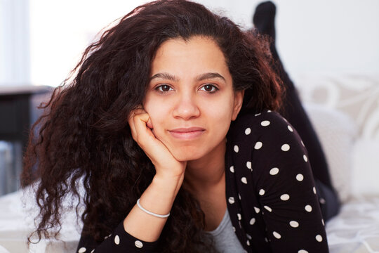 Mixed race woman laying on bed