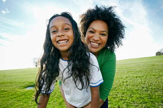 Portrait of smiling mixed raced mother and daughter