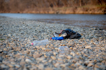 Garbage near the river. Environmental pollution shore