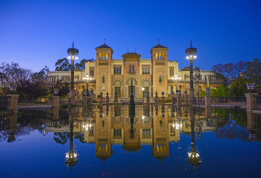Spain, Seville, Museum of Arts and Popular Customs of Seville reflecting in pond