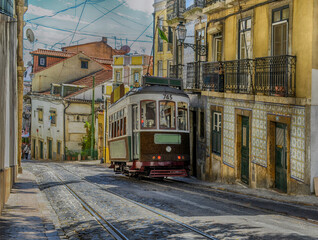 Naklejka na ściany i meble Vintage yellow tram in the city center of Lisbon, Portugal