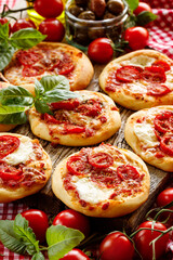 Pizza with cherry tomatoes and mozzarella cheese close up view