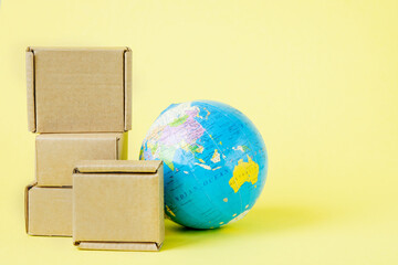 Earth globe is surrounded by boxes. Global business and international transportation of goods products. Shipping freight, world trade and economics. Distribution, import export. Commodity turnover