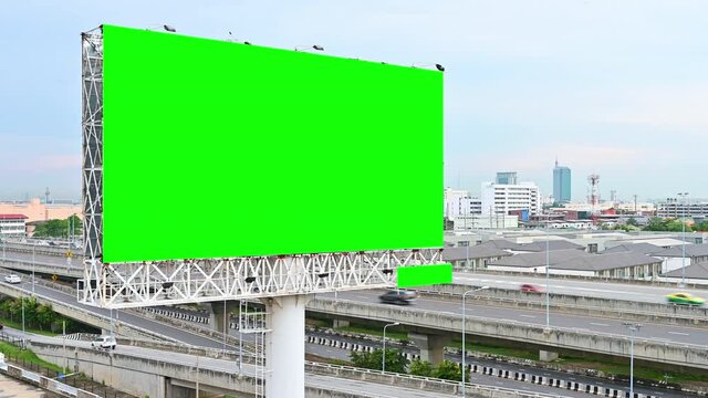 Advertising billboard green screen beside the expressway with car motion blur