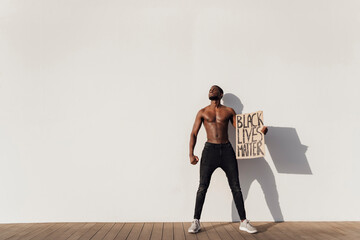 Black man holding Black Lives Matter sign