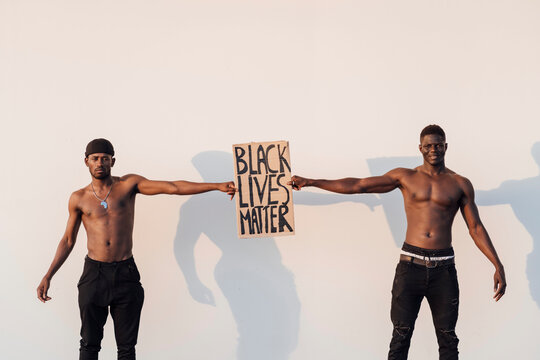 Two black men holding Black Lives Matter sign