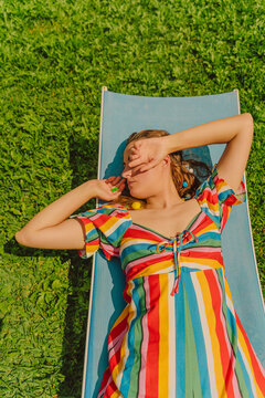 Woman relaxing on sun lounger