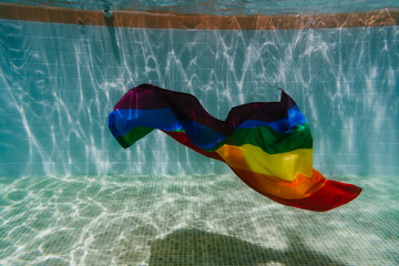 rainbow gay flag underwater in a pool.LGBTQ concept. Summertime. Nobody