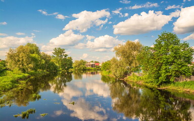 Village by the river with reflection