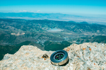 view from the top of the mountain to the mountains and the compass