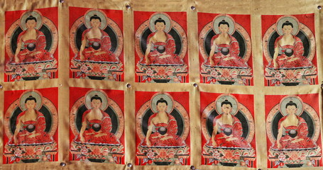 Fototapeta premium Tibetan thangka-Buddha Sakyamuni pinned to the wall. Thirty-three Heaven Grottoes-MatiSi-Zhangye-China-0982