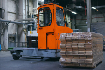 Timber Flooring Factory. Pile of cut wood in factory storage warehouse. Lumber in warehouse.