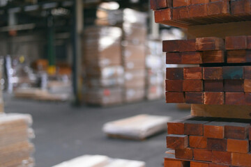 Timber Flooring Factory. Pile of cut wood in factory storage warehouse. Lumber in warehouse.