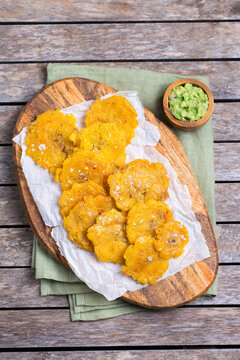 Fried tostones, green plantains, bananas with guacamole sauce
