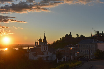 Fototapeta na wymiar Christian church on the banks of the Volga River at dawn. Nizhny Novgorod