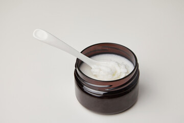 Dark jar with organic pure shea butter base oil. Natural cosmetics.