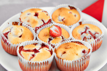 Homemade strawberry muffins on white plate