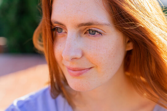 Portrait of redheaded woman looking sideways