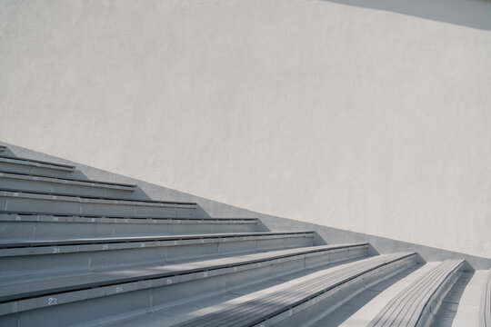 White wall and grey stairs in stadium