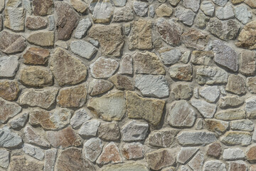 Texture of a stone wall of a castle fortress made of stones