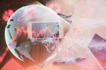 Double exposure of business theme hologram over desktop with phone. Top view. Mobile international trade connection concept.