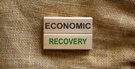 Wooden blocks with words 'economic recovery' on beautiful canvas background. Post-pandemic and business concept.