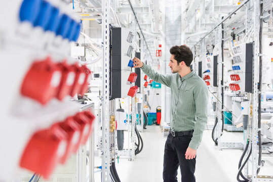 Man examining socket in a factory