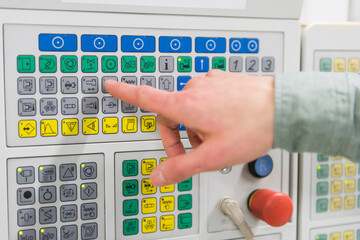 Close-up of man's finger with keypad