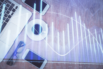 Multi exposure of financial chart hologram over desktop with phone. Top view. Mobile trade platform...