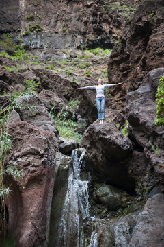 Female hiker at waterfall, Tenerife, Balearic Islands, Spain